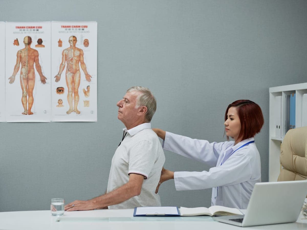 Neurosurgeon examining a patient's spine