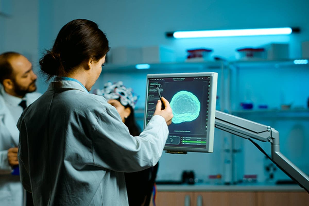 Clinician reviewing brain imaging on a monitor